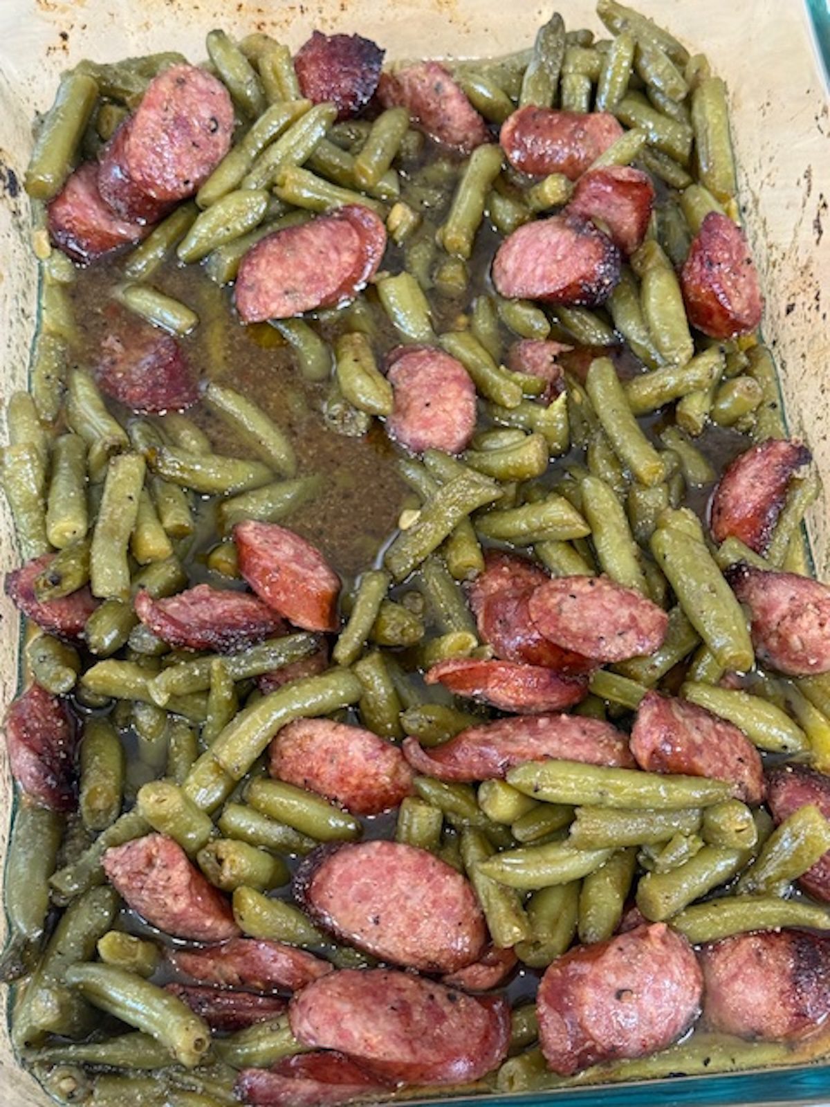 Finished baked green beans and smoked sausage.