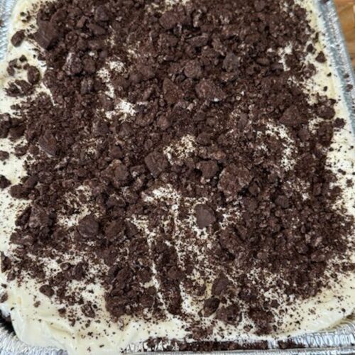 Finished no-bake Oreo dessert in an aluminum pan.
