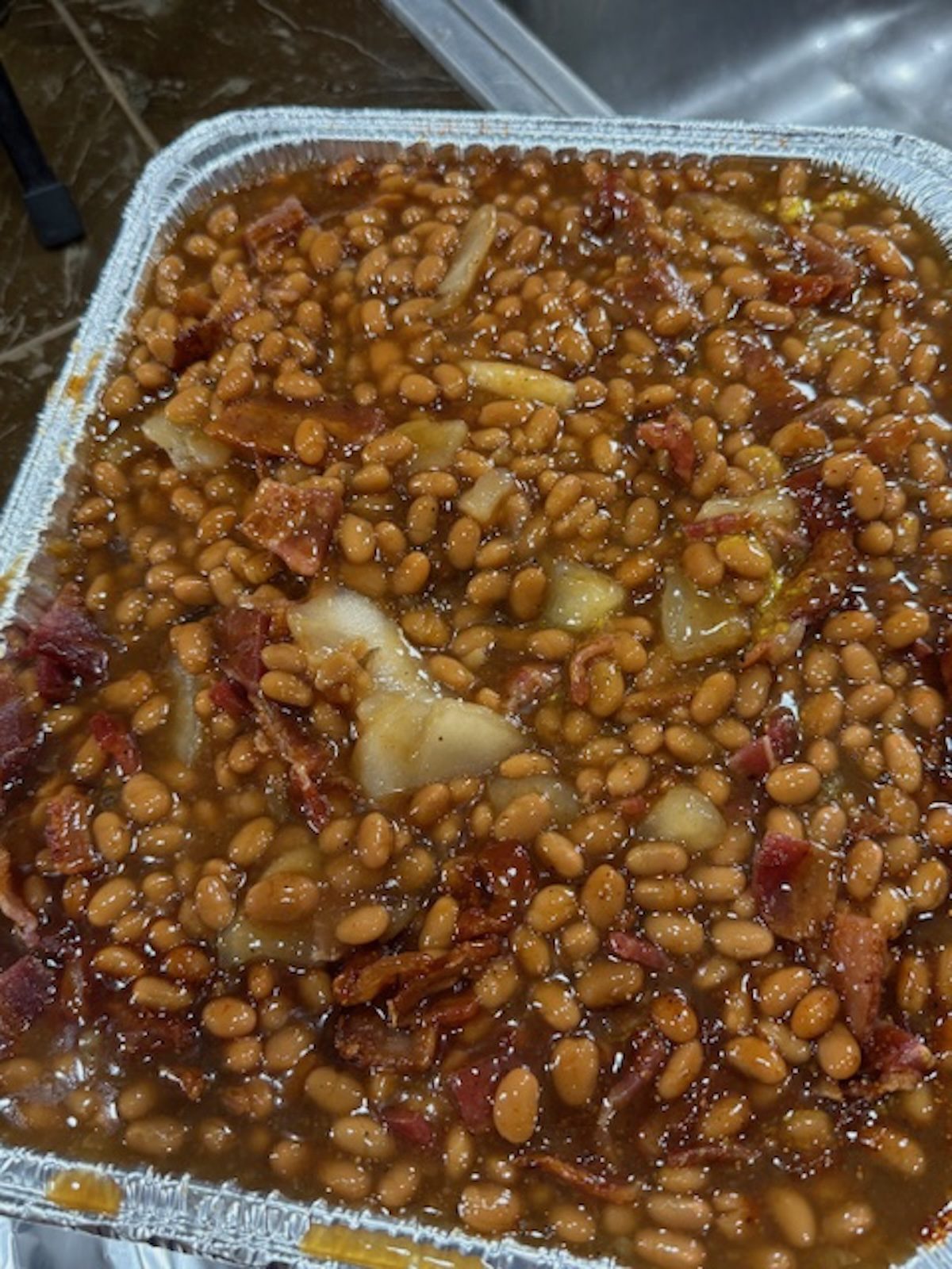 Apple pie baked beans in metal container.