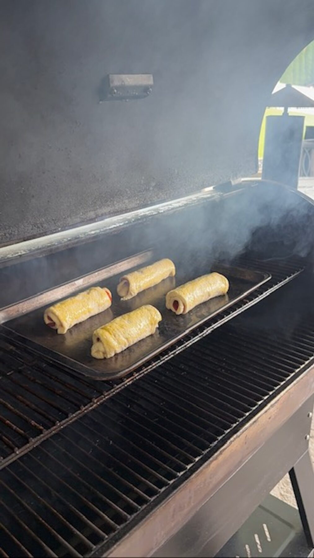 Pepperoni rolls on a skilled inside the grill.