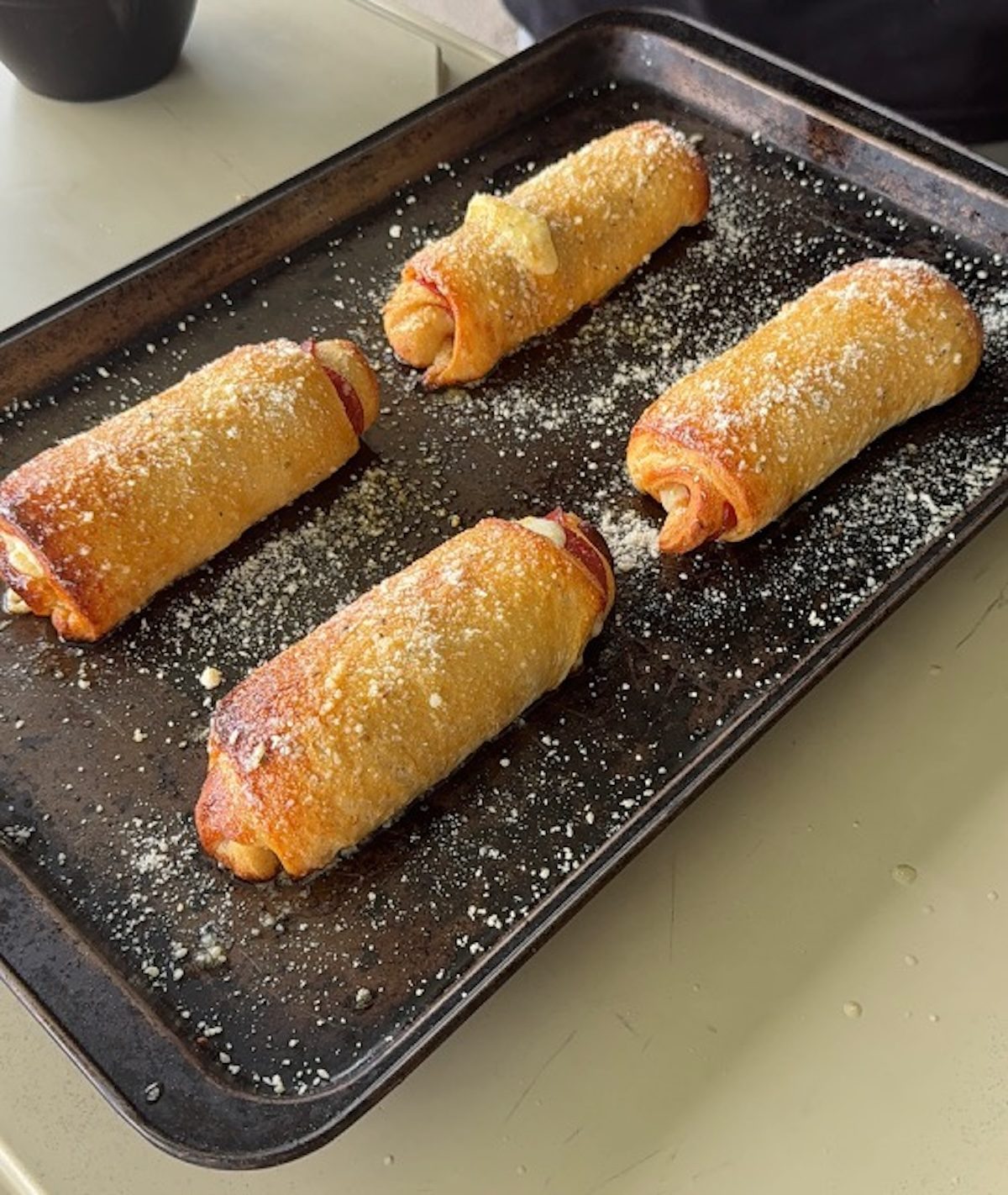 Pepperoni rolls sprinkled with parmesan cheese.