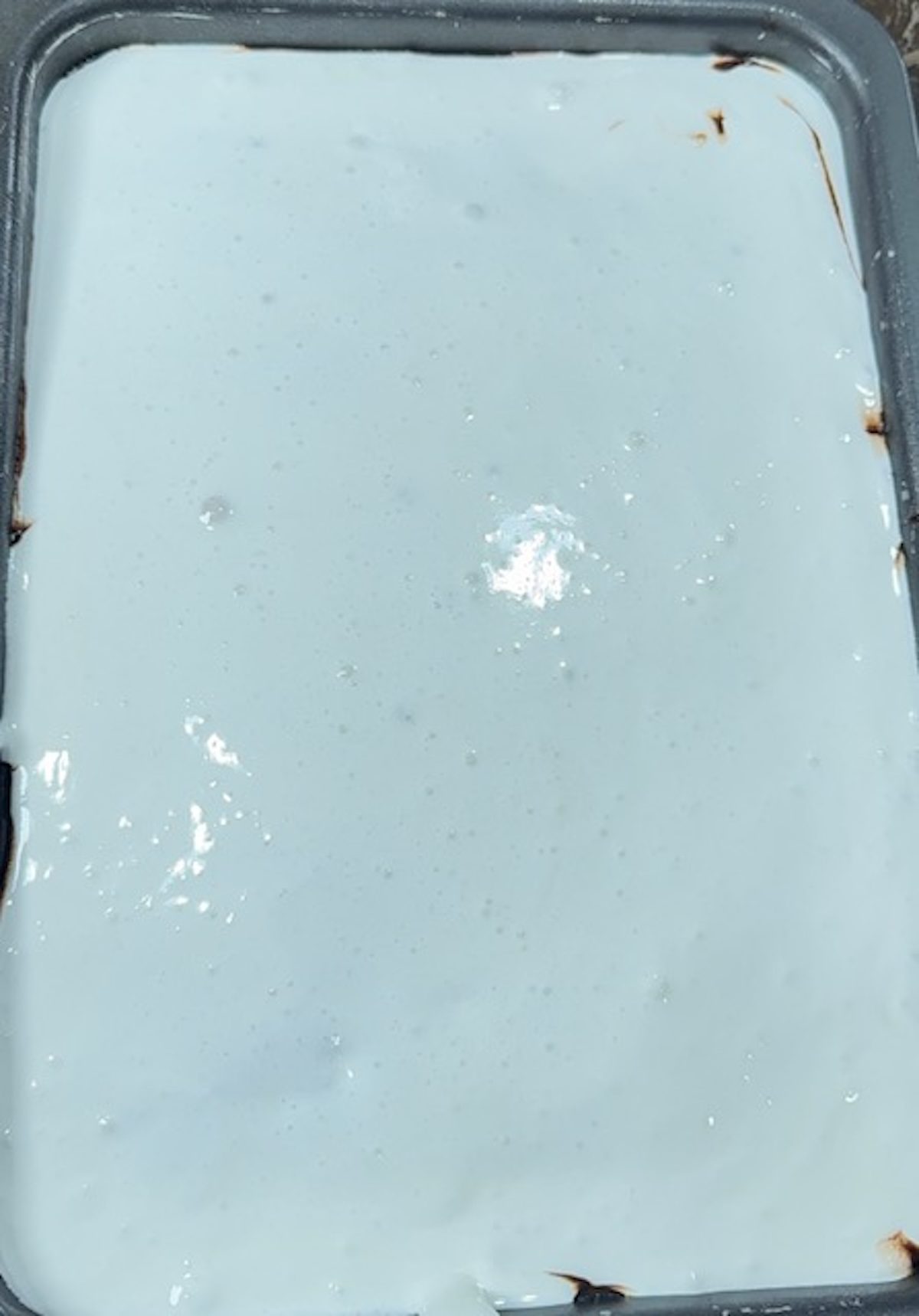 The marshmallow creme is spread over the Mississippi mud cake.