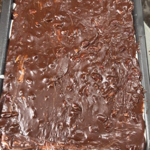 The chocolate glaze is poured over the top of the Mississippi mud cake.