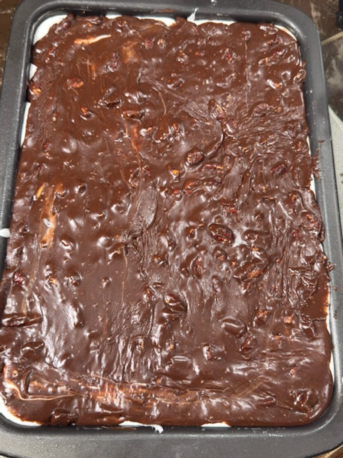 The chocolate glaze is poured over the top of the Mississippi mud cake.