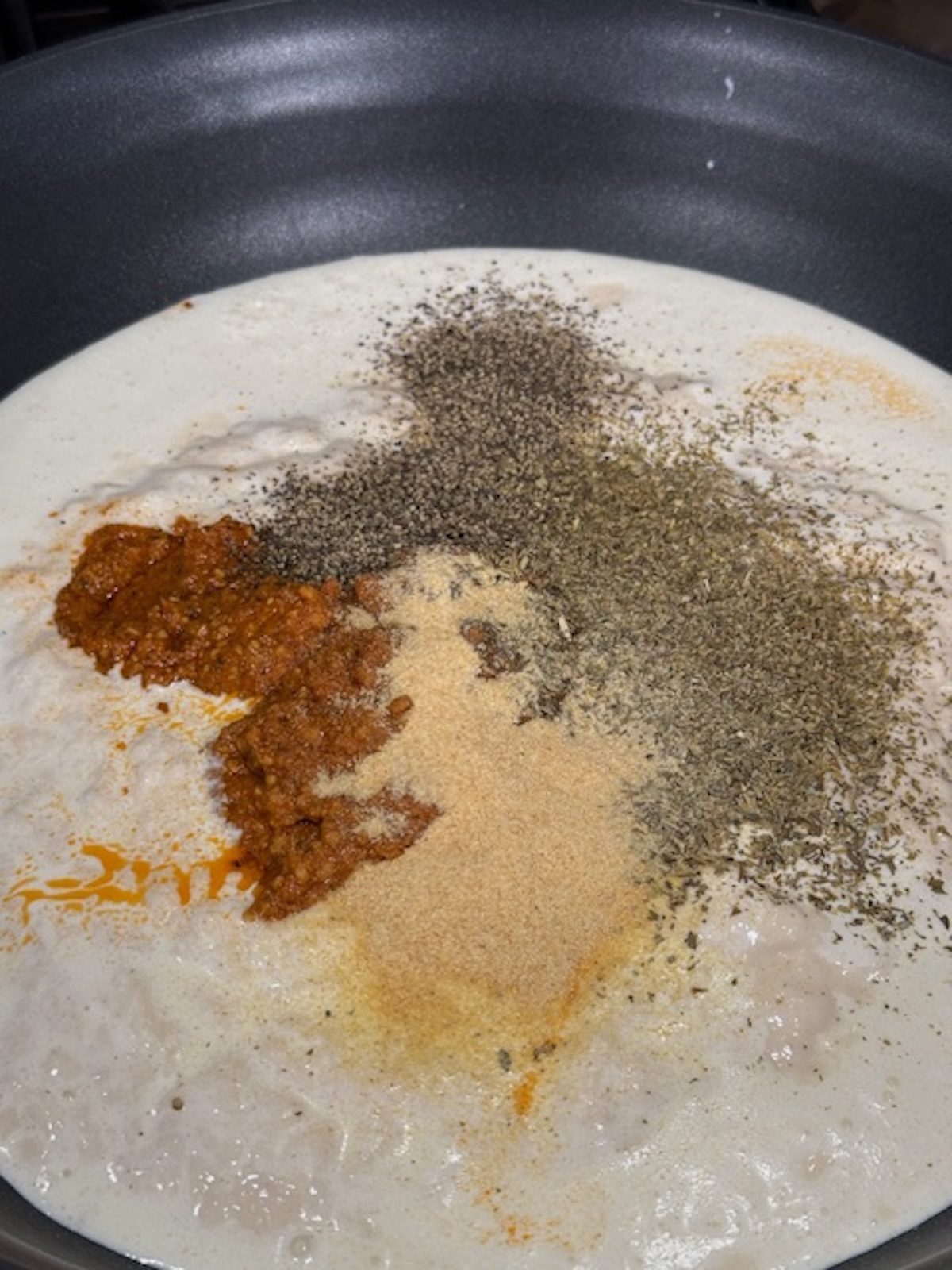 Spices added to the cream and sun dried tomato marry me pasta sauce.