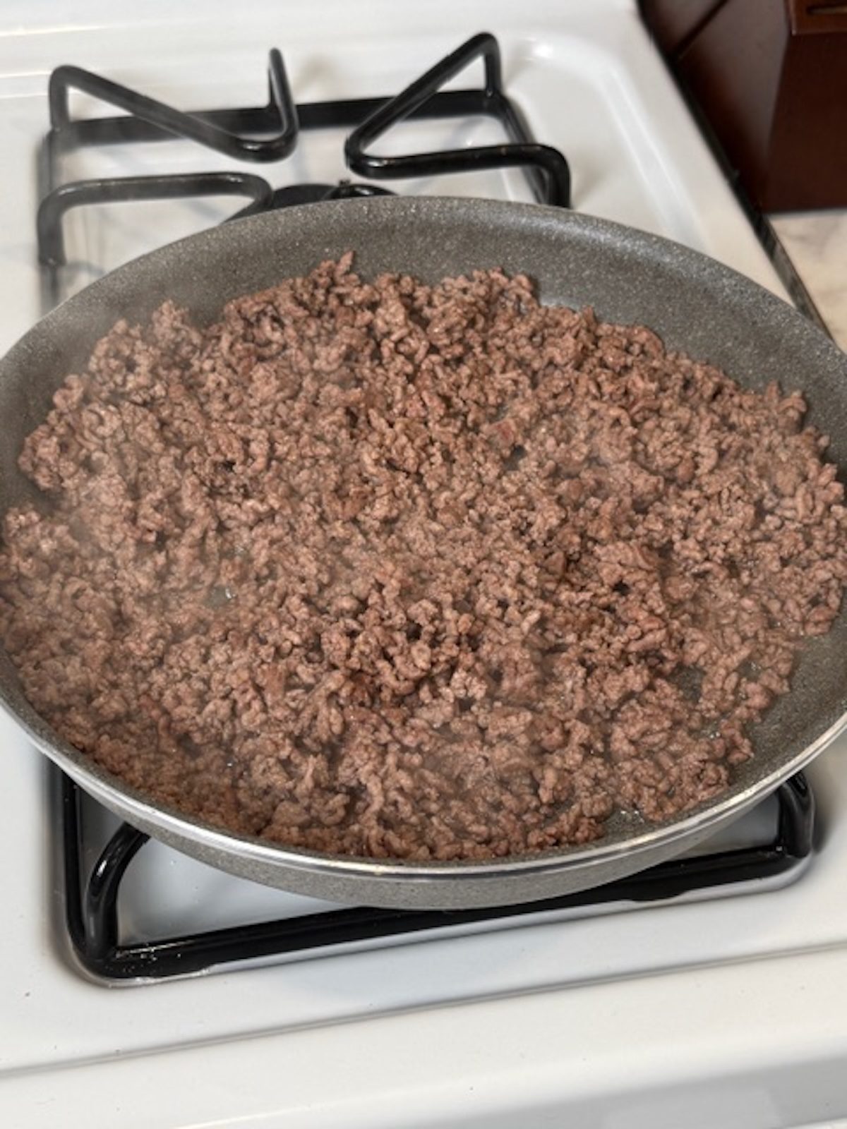 Ground beef is broken up and browned in a skillet.