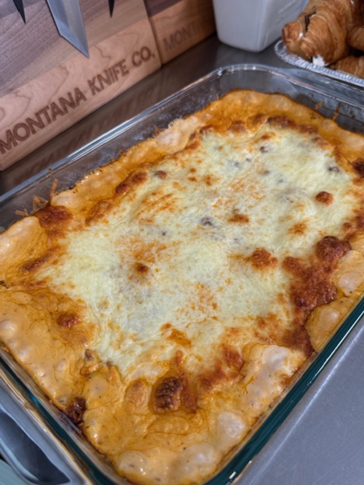 Baked million dollar tortellini bake in a glass baking dish.