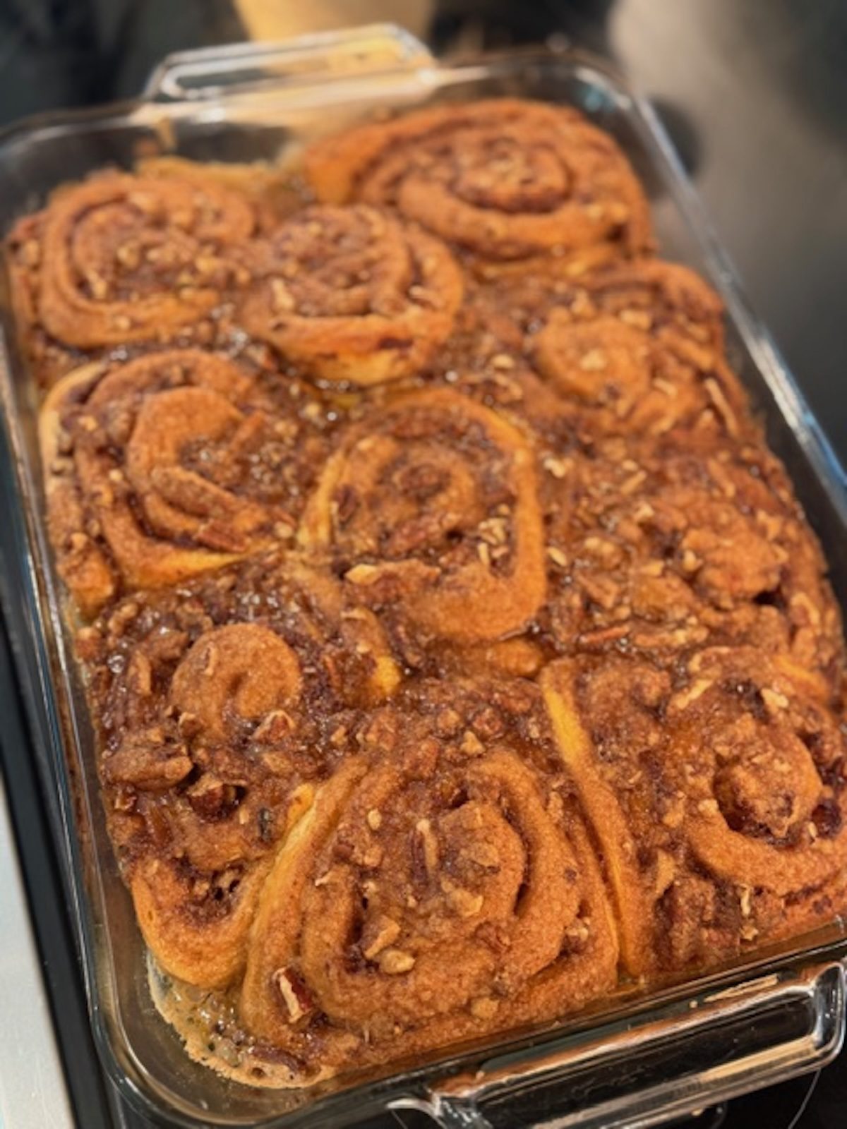 Baked easy cinnamon rolls in a glass baking dish.