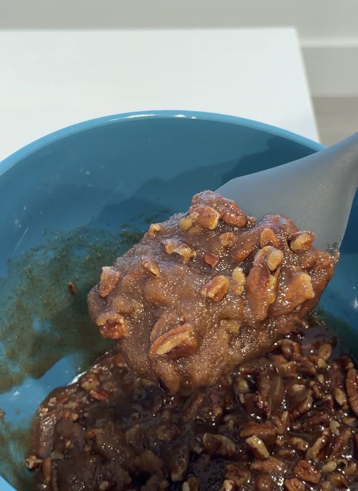 Rubber spatula with the caramel pecan mixture.