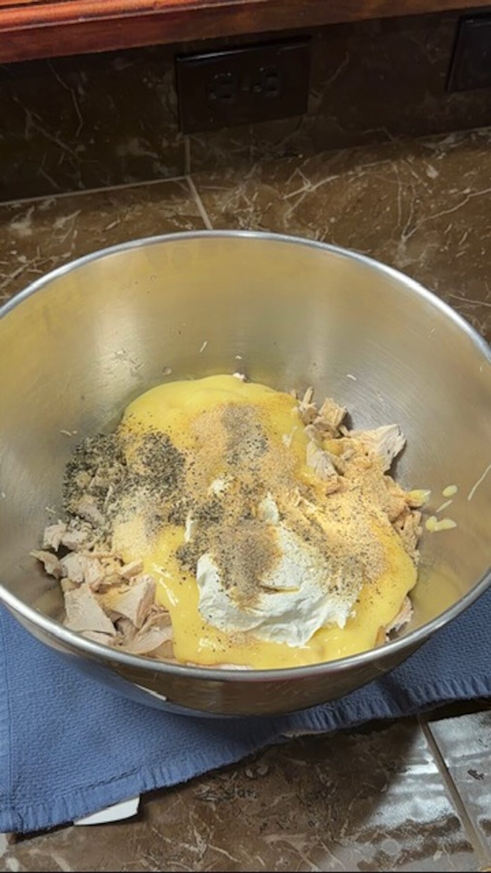 A metal bowl with poppyseed chicken casserole ingredients.