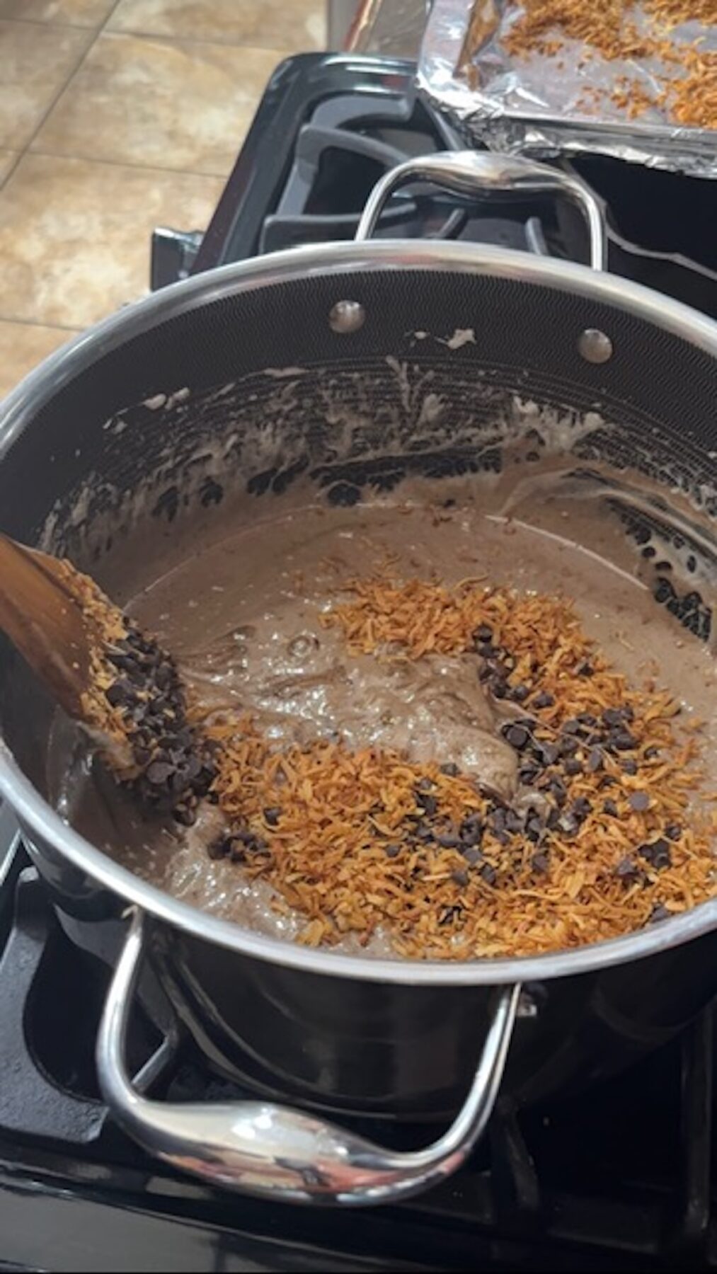 A large pot with marshmallows, chocolate chips, and toasted coconut.
