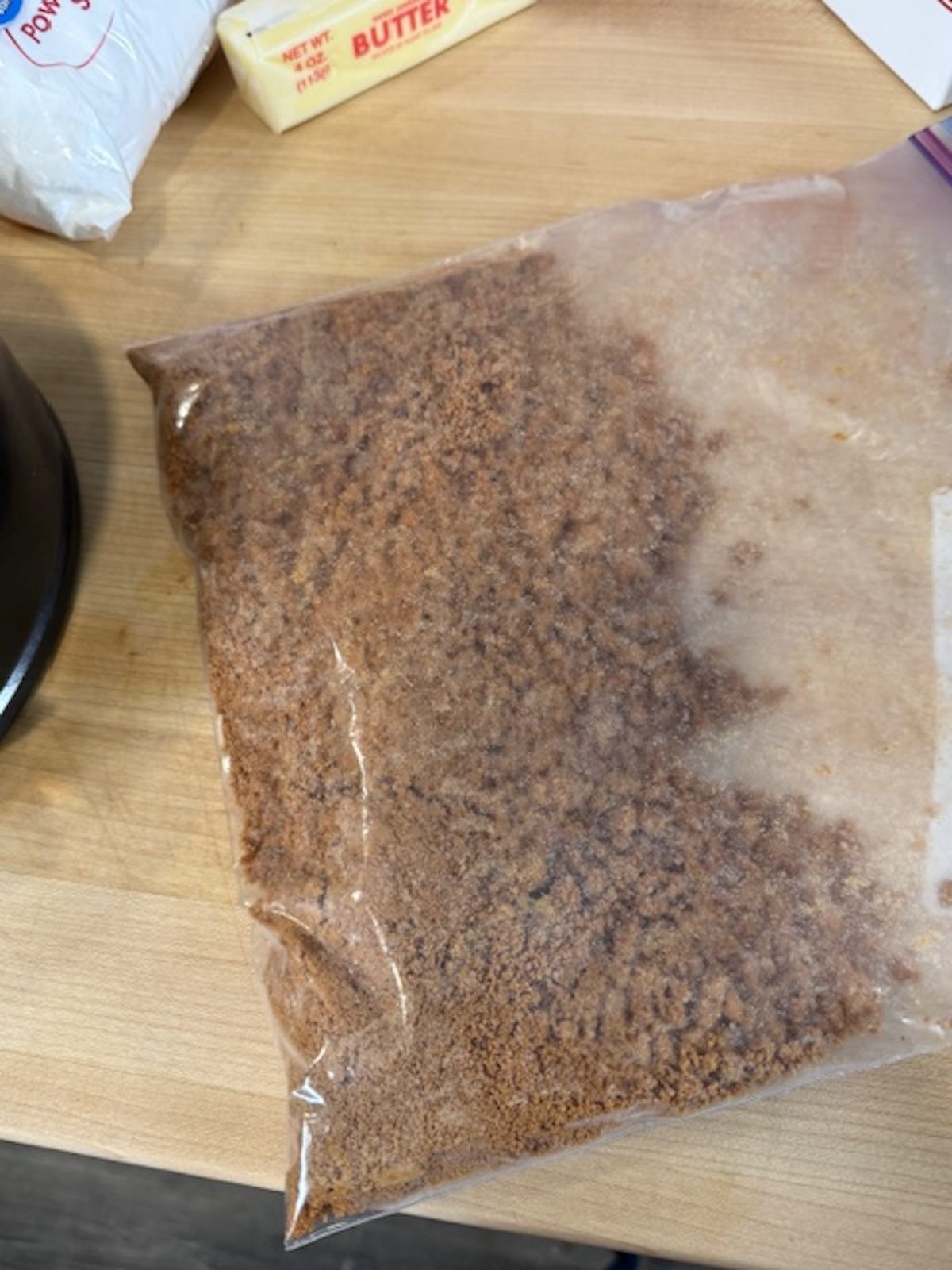 Crushed ingredients for biscoff no bake cheesecake crushed in plastic bag.