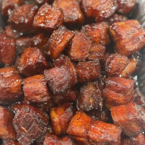 Pork belly burnt ends in a silver tray.