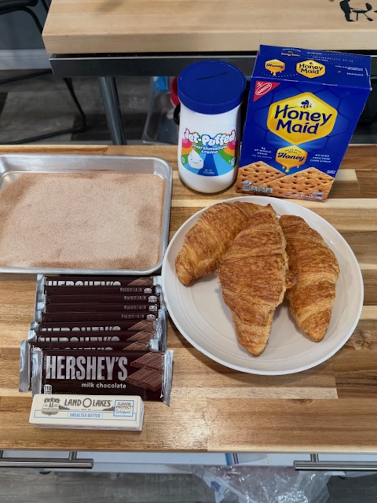 smores churros croissants ingredients on wooden counter