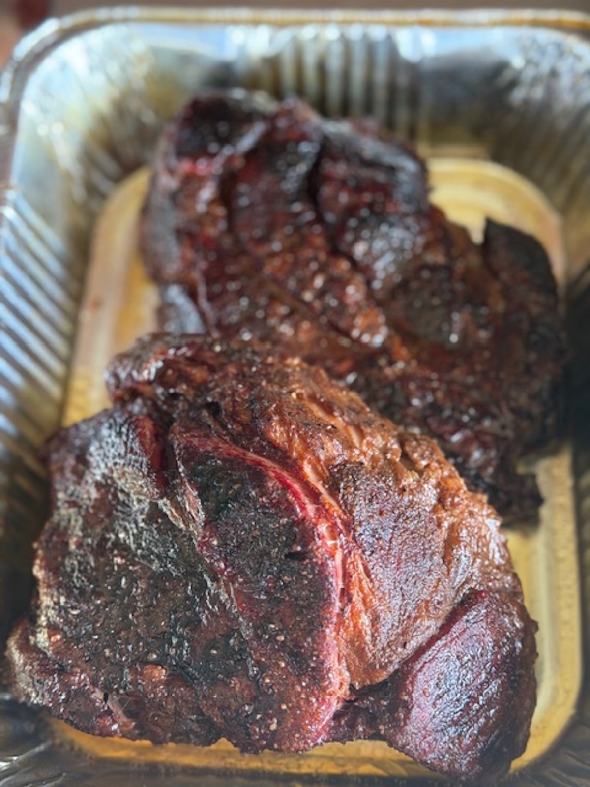 bby pulled beef cooked and whole in aluminum pan, not shredded yet