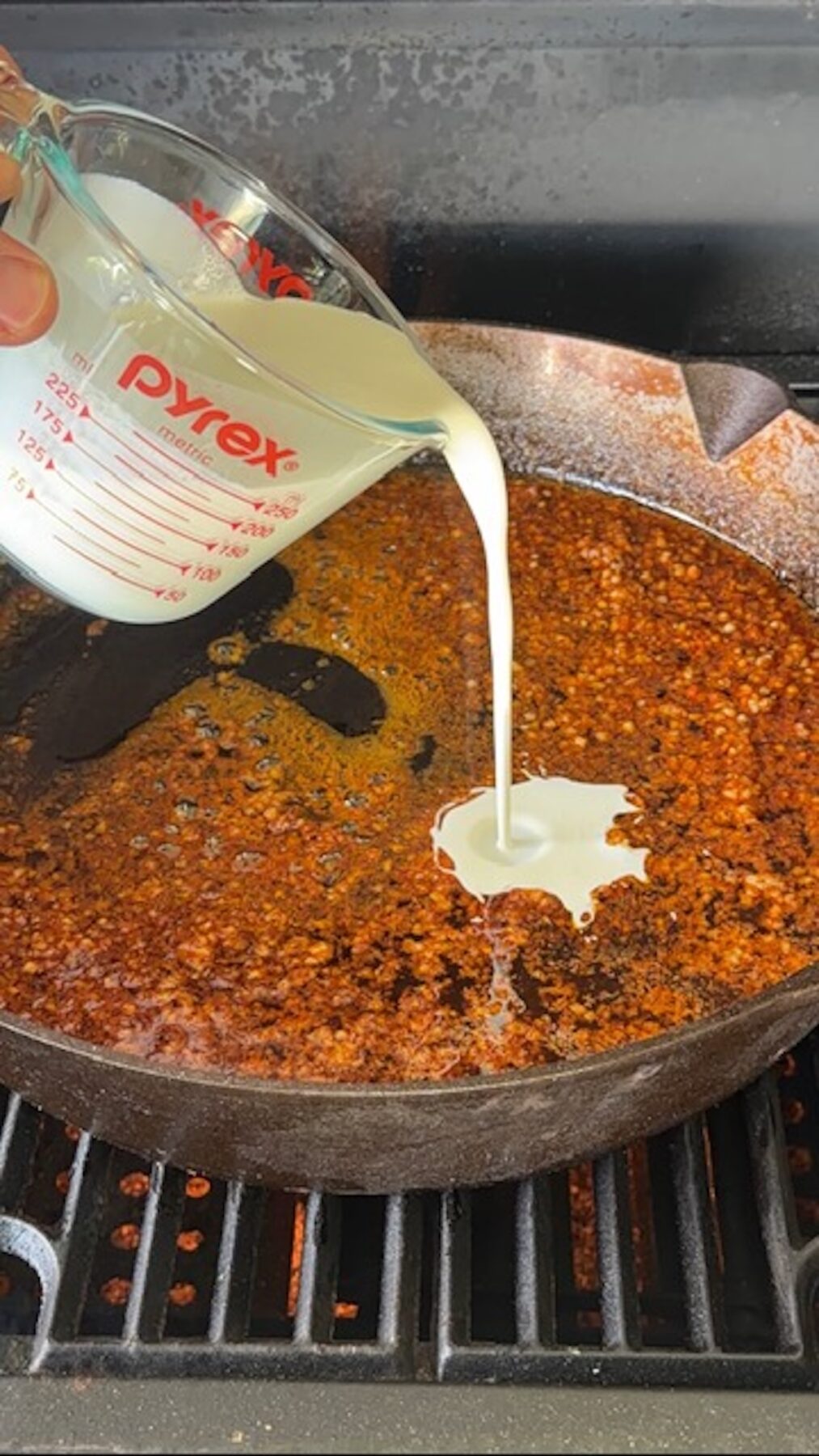 Creamy being added to cast iron with melted butter and spices.