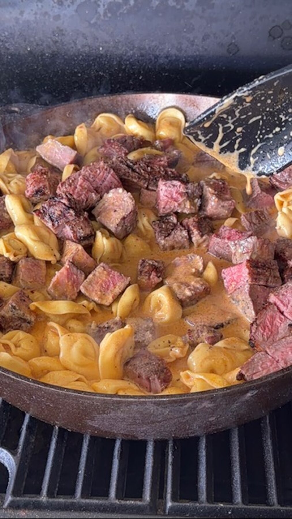 Cast iron with melted butter and spices, and steak pieces.