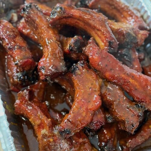 party ribs sauced and cooked, and cut, in aluminum tray