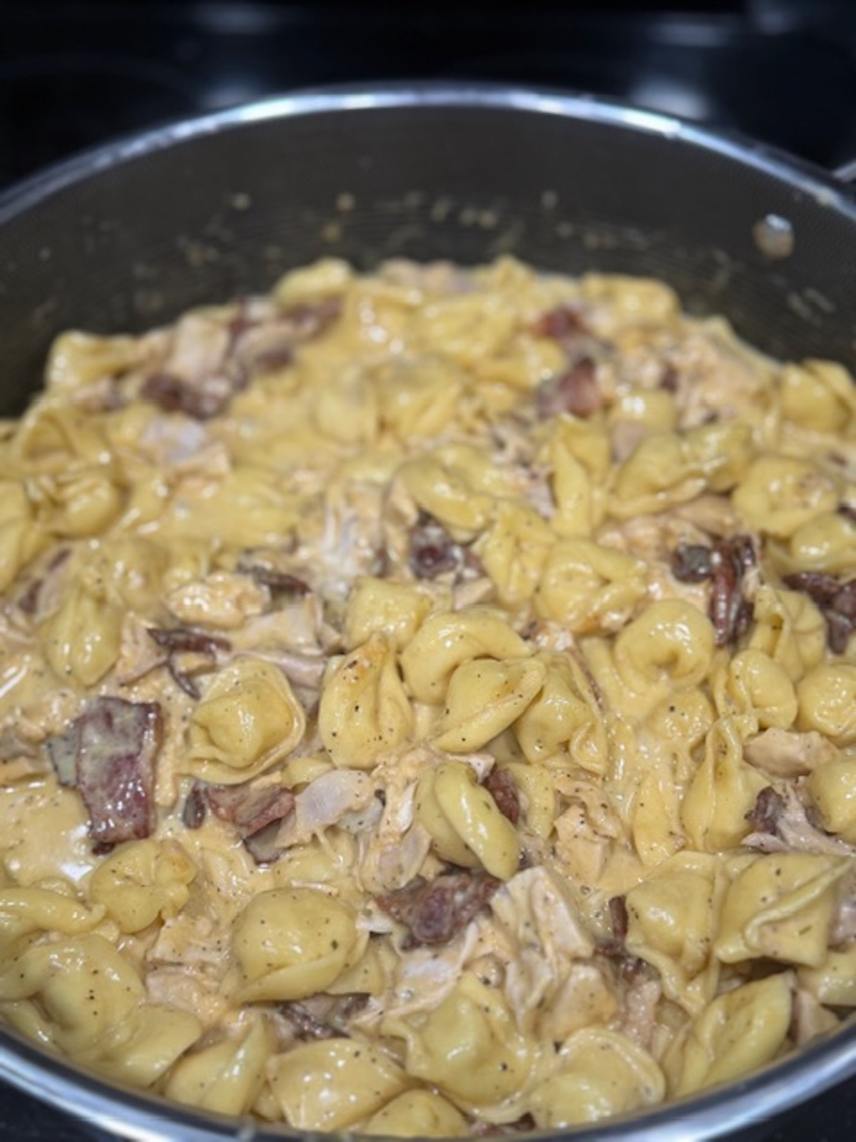 A skillet with chicken bacon ranch tortellini.