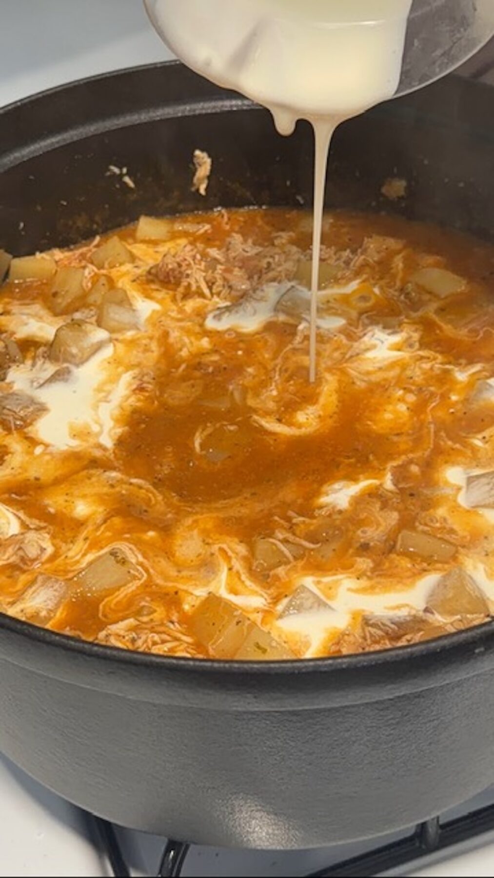 cream mixture being added into marry me chicken potato soup