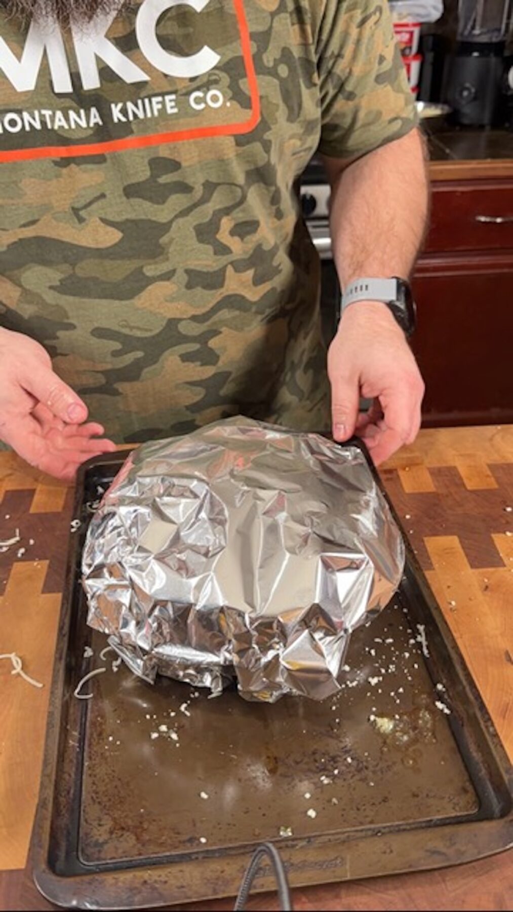 Foil covering the cheesy pull apart bread before baking.