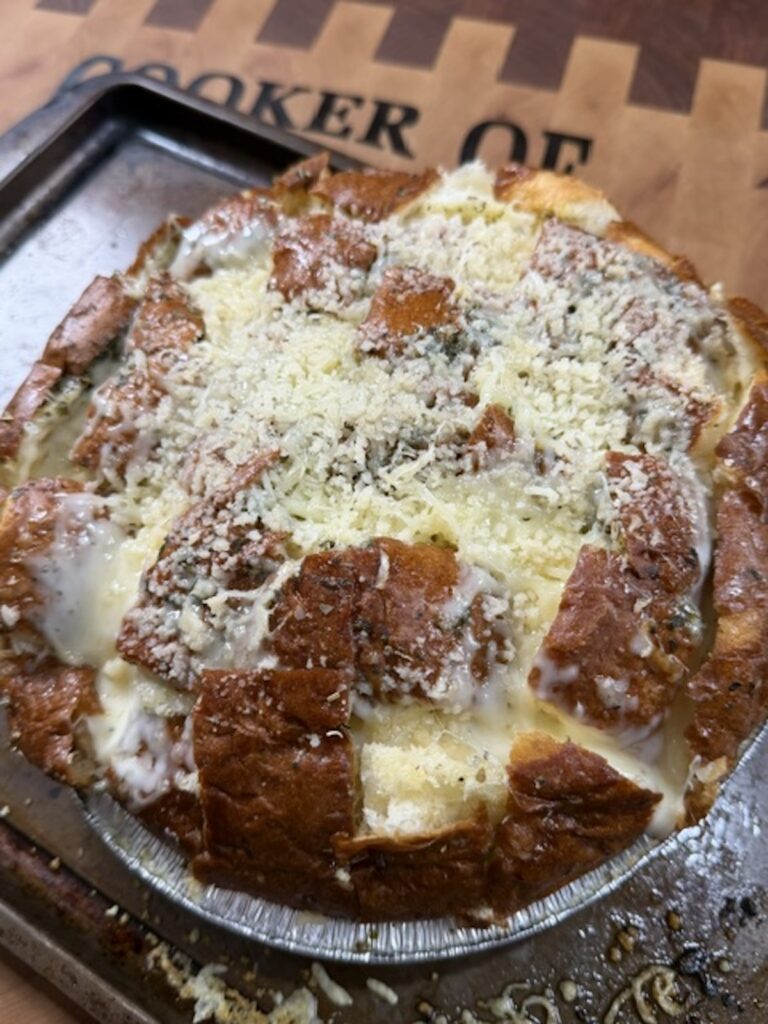 Close up of baked cheesy pull apart bread.