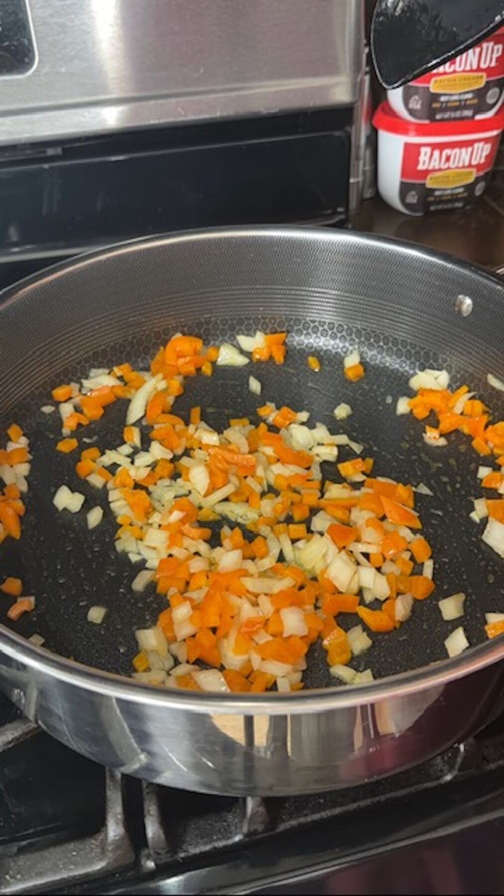 veggies being sauteed in pan on stove